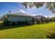 Landscaped backyard with screened-in lanai and views of lawn at 1279 Vermeer Dr, Nokomis, FL 34275