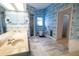 En suite bathroom featuring blue patterned wallpaper, a double vanity, and step in shower at 1279 Vermeer Dr, Nokomis, FL 34275