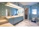 En suite bathroom featuring blue patterned wallpaper, a double vanity, and step in shower at 1279 Vermeer Dr, Nokomis, FL 34275