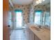 Nautical themed bathroom featuring a single sink vanity, toilet and a shower with glass doors at 1279 Vermeer Dr, Nokomis, FL 34275