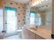 Nautical themed bathroom featuring a single sink vanity, toilet and a shower with glass doors at 1279 Vermeer Dr, Nokomis, FL 34275