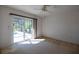 Sunlit bedroom featuring carpet and sliding glass doors overlooking the pool and backyard at 1279 Vermeer Dr, Nokomis, FL 34275