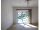 Sunlit bedroom featuring carpet and sliding glass doors overlooking the pool and backyard at 1279 Vermeer Dr, Nokomis, FL 34275