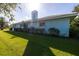 Single story home with light blue exterior, tile roof, lush lawn, and manicured landscaping at 1279 Vermeer Dr, Nokomis, FL 34275
