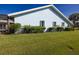 Exterior shot of home featuring a well-manicured lawn and screened in enclosure at 1279 Vermeer Dr, Nokomis, FL 34275