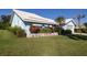 A light-blue home with a tiled roof and well-kept landscaping, complemented by a green lawn at 1279 Vermeer Dr, Nokomis, FL 34275