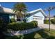Inviting light-blue home with a pristine garage, lush greenery, and well-kept landscaping at 1279 Vermeer Dr, Nokomis, FL 34275