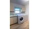 Laundry room with a sink, cabinets, and a washing machine and dryer at 1279 Vermeer Dr, Nokomis, FL 34275