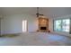 Open-concept living area with a stone fireplace, perfect for cozy evenings and gatherings at 1279 Vermeer Dr, Nokomis, FL 34275