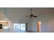 Living room featuring a ceiling fan and sliding doors to the pool area at 1279 Vermeer Dr, Nokomis, FL 34275