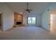 Spacious living room featuring a stone fireplace and a ceiling fan at 1279 Vermeer Dr, Nokomis, FL 34275