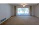 Neutral living room featuring carpet, ceiling fan, and sliding glass doors to pool at 1279 Vermeer Dr, Nokomis, FL 34275