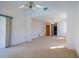 Spacious living room with ceiling fans, carpeted floors, and sliding glass doors that let in plenty of natural light at 1279 Vermeer Dr, Nokomis, FL 34275