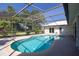 Screened in pool with tile surround and private backyard view at 1279 Vermeer Dr, Nokomis, FL 34275