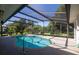 Screened in pool with tile surround and lush landscaping at 1279 Vermeer Dr, Nokomis, FL 34275
