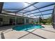 Screened in pool with tile surround and views of the home's exterior at 1279 Vermeer Dr, Nokomis, FL 34275