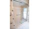 Shower with glass doors with a mermaid design on them with nautical themed wallpaper surrounding it at 1279 Vermeer Dr, Nokomis, FL 34275