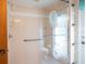 Shower with glass doors with a mermaid design on them with nautical themed wallpaper surrounding it at 1279 Vermeer Dr, Nokomis, FL 34275