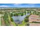 Beautiful aerial view of a tranquil pond surrounded by lush greenery and residential houses at 13108 Torresina Ter, Bradenton, FL 34211