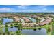 Breathtaking aerial view of residential houses with a pond and lush green landscaping, offering tranquil scenery at 13108 Torresina Ter, Bradenton, FL 34211