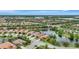 Picturesque aerial view of homes by a serene pond, capturing the beauty of community living at 13108 Torresina Ter, Bradenton, FL 34211