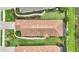 An aerial shot showing a home with manicured lawn, a beautiful roof, and landscaped walkway at 13108 Torresina Ter, Bradenton, FL 34211