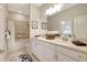 Bright bathroom with a double sink vanity, tile floors, and a shower/tub combination offers comfort and style at 13108 Torresina Ter, Bradenton, FL 34211