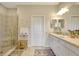 Bright bathroom with glass enclosed shower, double vanity, and tile flooring at 13108 Torresina Ter, Bradenton, FL 34211