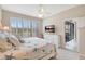 Relaxing bedroom with a view of the outdoors and white dresser with a television at 13108 Torresina Ter, Bradenton, FL 34211