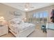 Cozy bedroom with beach-themed decor, ceiling fan, and a view of the outdoors through the window at 13108 Torresina Ter, Bradenton, FL 34211