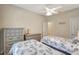 Bright bedroom features twin beds, ceiling fan, dressers, and coastal-themed décor for a serene atmosphere at 13108 Torresina Ter, Bradenton, FL 34211