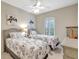 Bright bedroom features twin beds, ceiling fan, shutters, and coastal-themed décor for a relaxing getaway at 13108 Torresina Ter, Bradenton, FL 34211