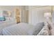Bright bedroom with coastal decor, white furnishings, and nearby bathroom access, creating a comfortable living space at 13108 Torresina Ter, Bradenton, FL 34211