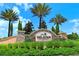 Community entrance sign for Esplanade Golf and Country Club, surrounded by palm trees and lush landscaping at 13108 Torresina Ter, Bradenton, FL 34211
