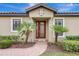 Inviting front entrance with a brick walkway, decorative front door, lush landscaping and a modern design at 13108 Torresina Ter, Bradenton, FL 34211