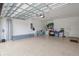 Spacious garage with epoxy flooring, overhead door mechanism, and ample space for parking and storage at 13108 Torresina Ter, Bradenton, FL 34211