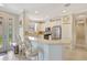 Bright kitchen with white cabinets, stainless steel appliances, tile flooring, and breakfast bar with seating at 13108 Torresina Ter, Bradenton, FL 34211