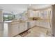 Bright kitchen with white cabinets, stainless steel appliances, and view to the living room at 13108 Torresina Ter, Bradenton, FL 34211