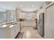Bright kitchen with white cabinets, stainless steel appliances, tile flooring, and breakfast bar at 13108 Torresina Ter, Bradenton, FL 34211