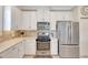 Bright kitchen with white cabinets, stainless steel appliances, and tile backsplash at 13108 Torresina Ter, Bradenton, FL 34211