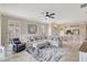 Comfortable living room featuring a sectional sofa, ceiling fan, and open layout to the kitchen at 13108 Torresina Ter, Bradenton, FL 34211