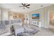 Spacious living room with stylish furniture, a ceiling fan, and an open-concept design at 13108 Torresina Ter, Bradenton, FL 34211