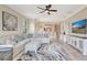 Bright living room with sectional sofa, stylish rug, ceiling fan, and white entertainment center at 13108 Torresina Ter, Bradenton, FL 34211