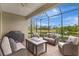 Relaxing screened-in patio with comfortable seating, a ceiling fan, and a view of the lake at 13108 Torresina Ter, Bradenton, FL 34211