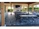 An outdoor patio with tables, chairs, and a fireplace, perfect for entertaining and relaxation at 13108 Torresina Ter, Bradenton, FL 34211