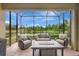 Inviting screened-in patio with comfortable seating and a view of a serene lake at 13108 Torresina Ter, Bradenton, FL 34211