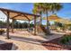 Community tennis area with shaded pavilion and seating, perfect for socializing and spectating at 13108 Torresina Ter, Bradenton, FL 34211