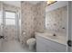 Bathroom featuring a single vanity and standing shower, all adorned with beautiful wallpaper at 1654 Waxwing Ct, Venice, FL 34293