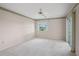 Large bedroom with soft carpet and sliding glass doors letting in the bright Florida sunshine at 1654 Waxwing Ct, Venice, FL 34293