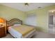 Bedroom with yellow walls, carpet, closet, and ceiling fan at 1654 Waxwing Ct, Venice, FL 34293